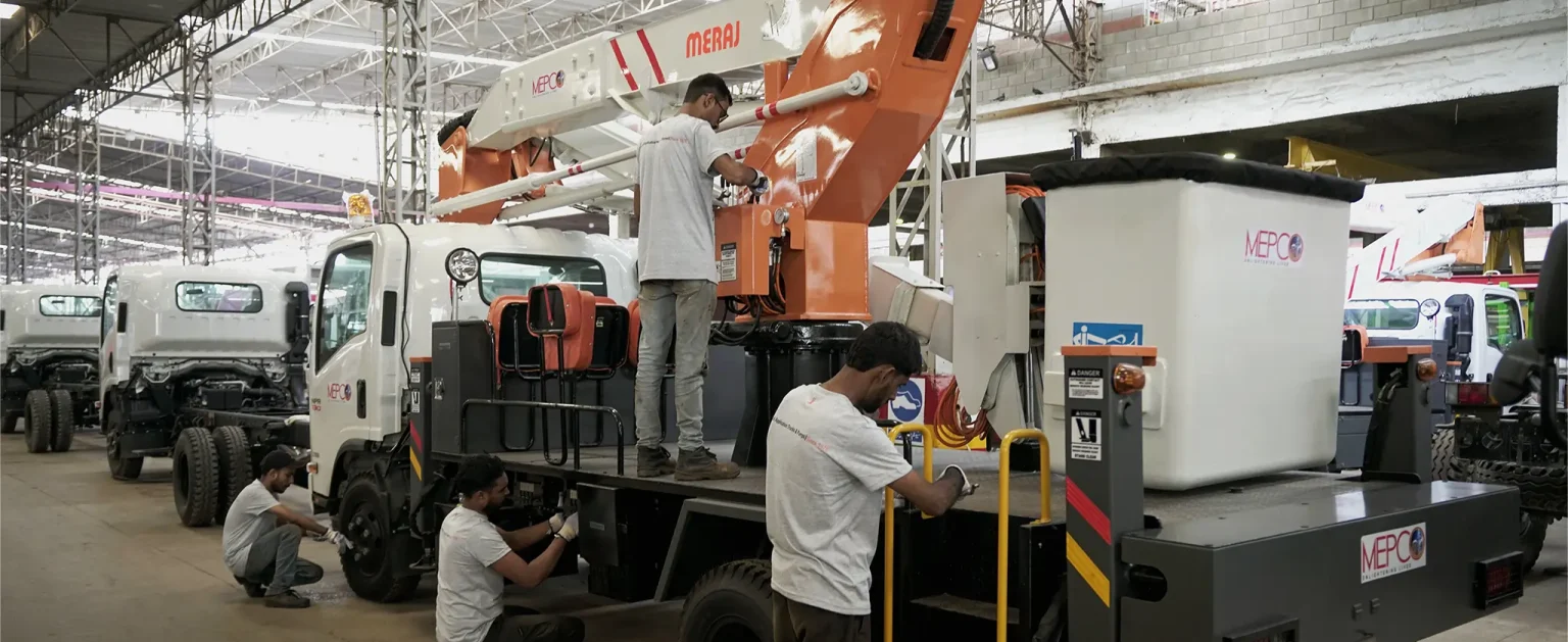 Meraj technicians servicing a truck-mounted aerial platform